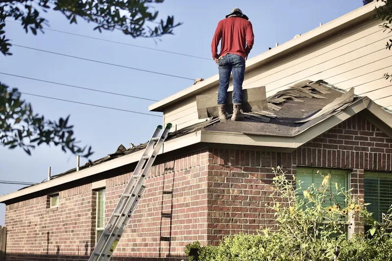 Professional roofer working on a residential roof in North East